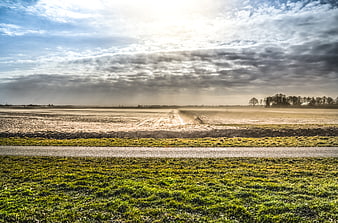 Dramatic Dust Storm Over Rural Landscape with Sunbeams