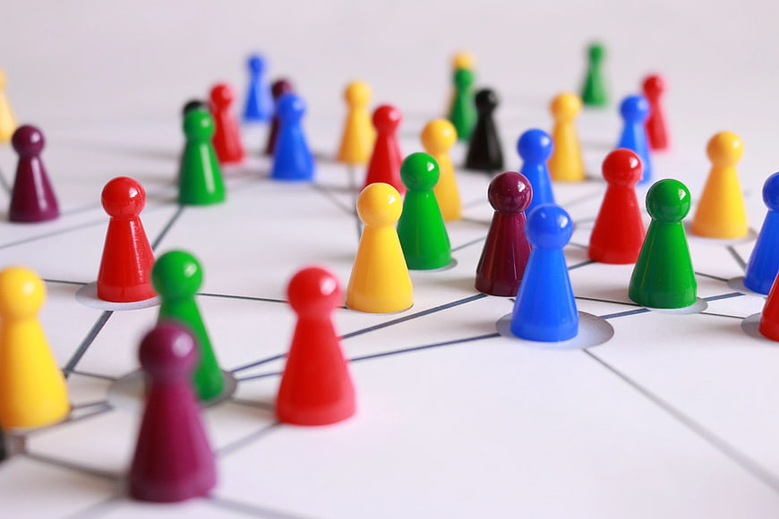 Colorful game pieces on network diagram representing teamwork