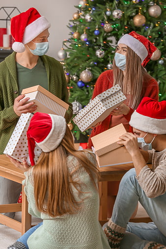 Friends Exchanging Christmas Gifts Wearing Face Masks