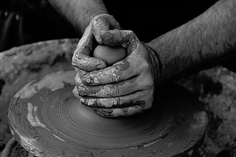 Close-up of hands shaping clay on a pottery wheel