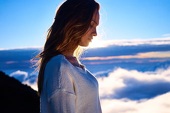 Woman in White Sweater Looking at Mountain Clouds