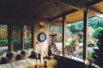 Modern rustic living room with large windows and garden view