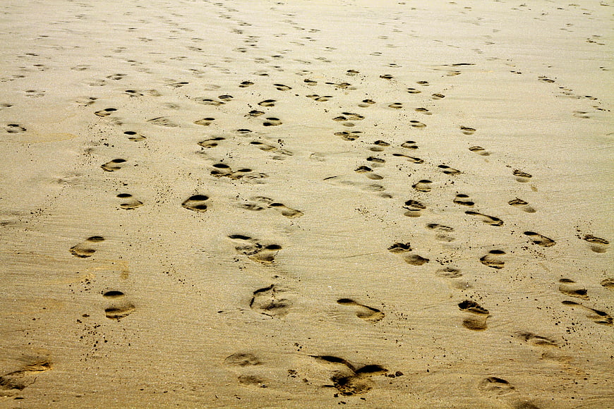 Footprints in sand on a sunny beach