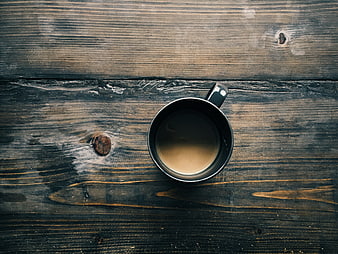 Top view of coffee cup on rustic dark wooden table