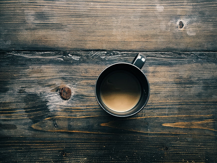 Top view of coffee cup on rustic dark wooden table