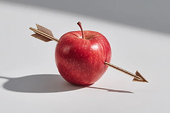 Red Apple Pierced by Golden Arrow on White Background