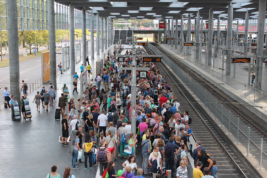 Crowded Train Station Platform With Waiting Passengers