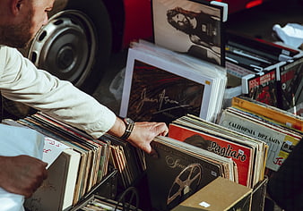 Man browsing vinyl records at outdoor flea market