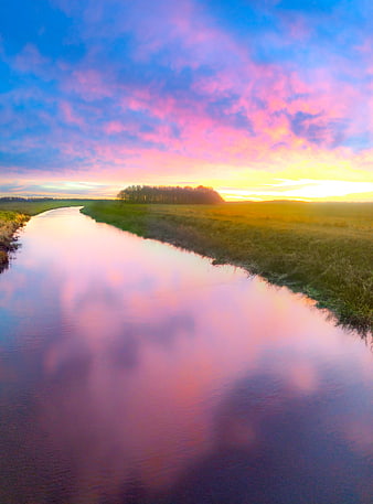Serene River at Sunset with Vibrant Pink and Blue Sky Reflection