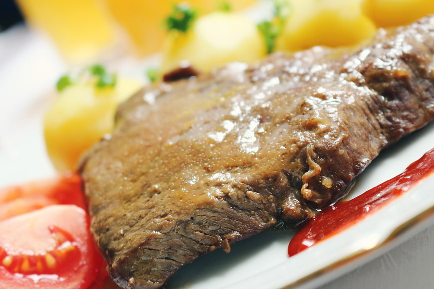 Close-up of Roast Beef with Potatoes and Tomatoes