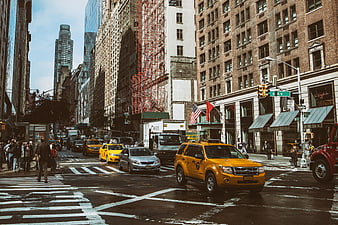 Busy New York City street scene with yellow taxis