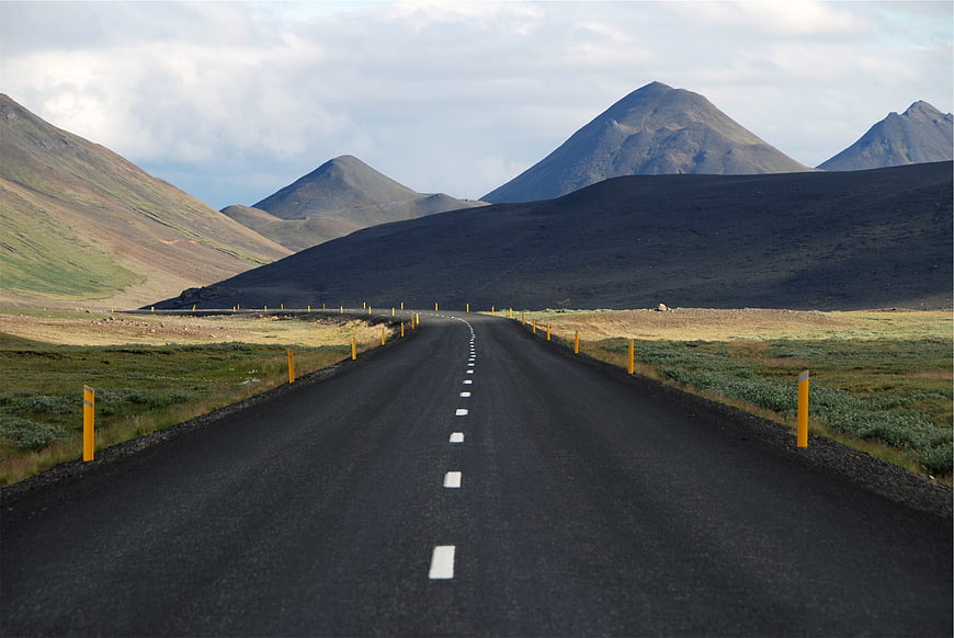 Asphalt Road Leading to Volcanic Mountains in Iceland