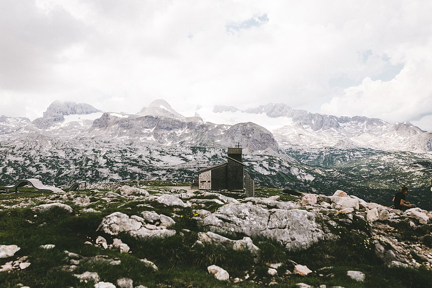 Small stone chapel in rocky alpine mountain landscape
