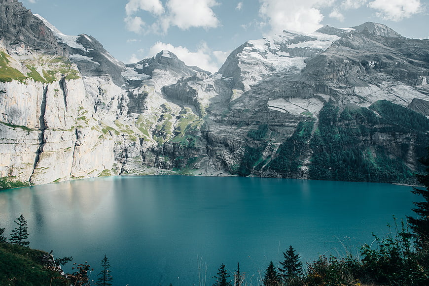Turquoise Alpine Lake Surrounded by Snowy Mountains