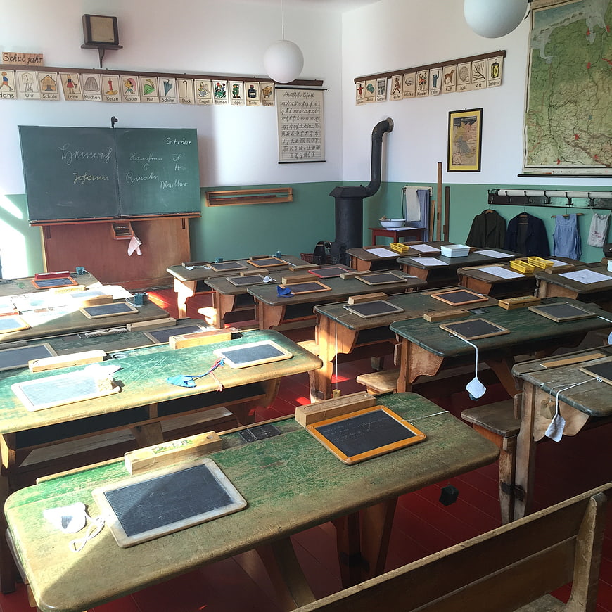 Vintage Classroom Interior with Wooden Desks and Chalkboard