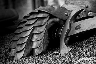Close-up of medieval knight armor with gauntlet and sword