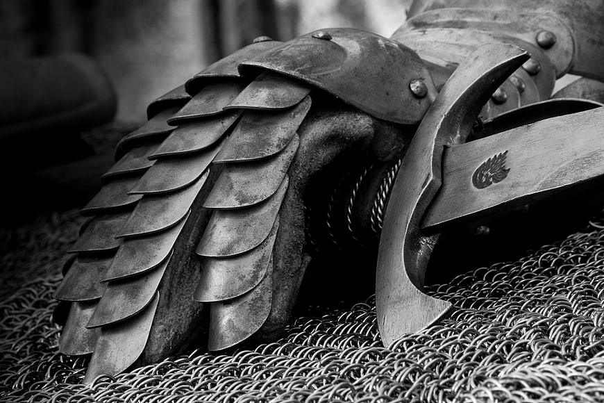 Close-up of medieval knight armor with gauntlet and sword