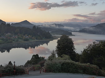 Serene Lake Sunrise with Misty Mountains and Reflections