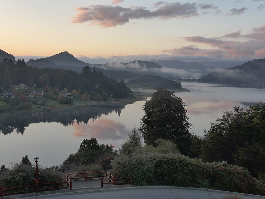 Serene Lake Sunrise with Misty Mountains and Reflections