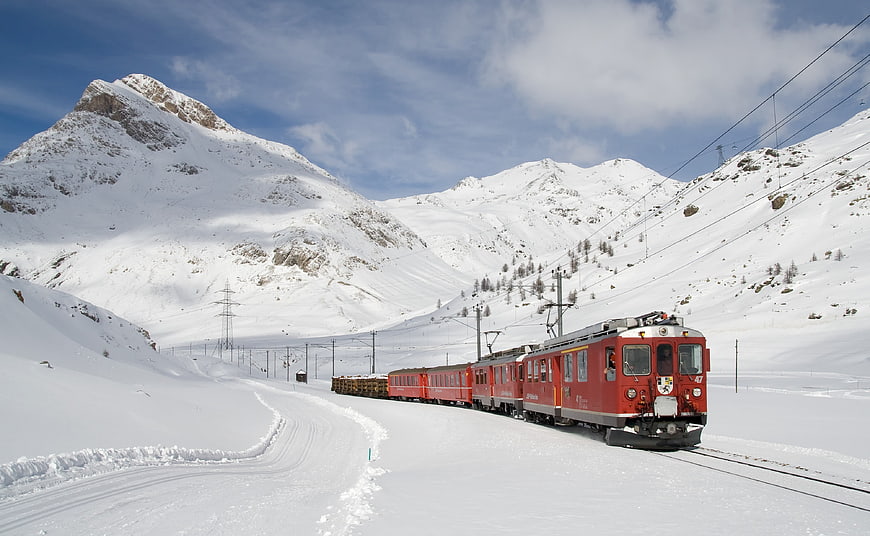 Red Bernina Railway Train in Snowy Swiss Alps