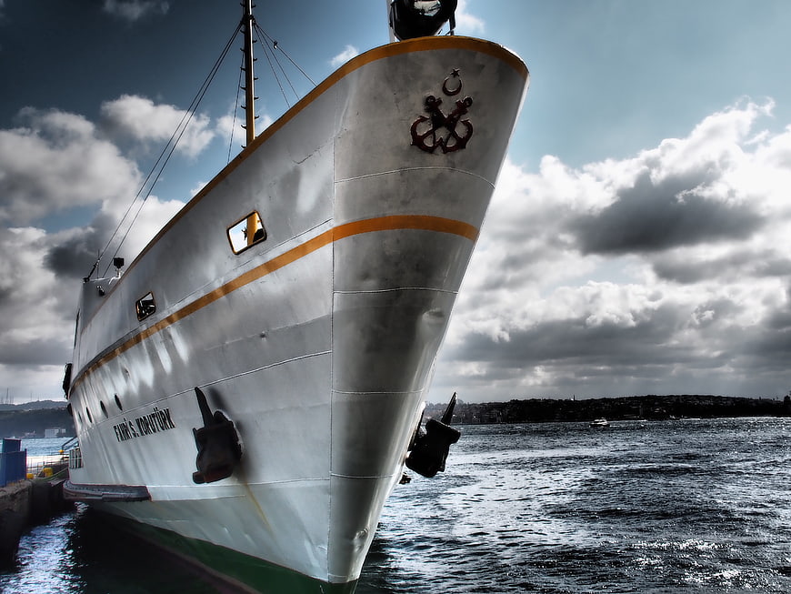 White Ferry Ship Docked at Port with Dramatic Sky