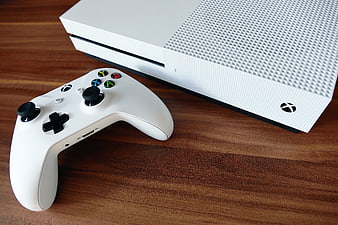 White Xbox One S Console and Controller on Wooden Table