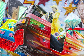Boy on Red Carnival Ride Car with Peace Sign