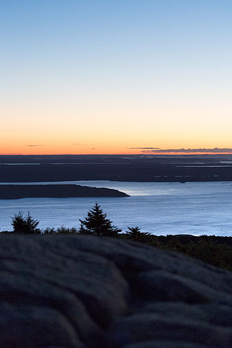 Serene Sunset Over Ocean and Distant Islands