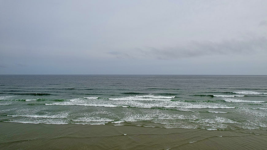 Aerial View of Calm Ocean Waves on Overcast Day