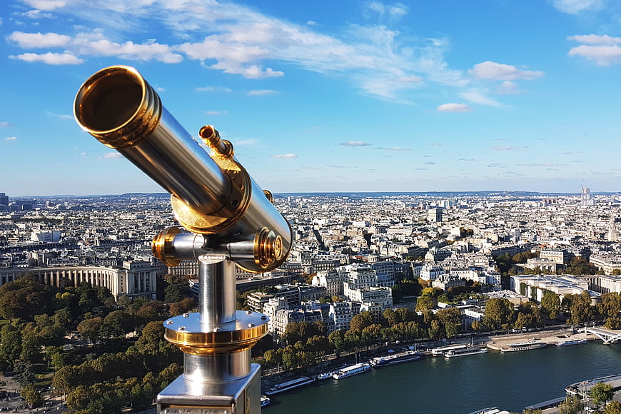 Golden Telescope Overlooking Paris Cityscape and Seine River