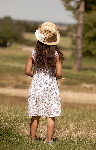 Little Girl in Straw Hat Looking at Summer Fields