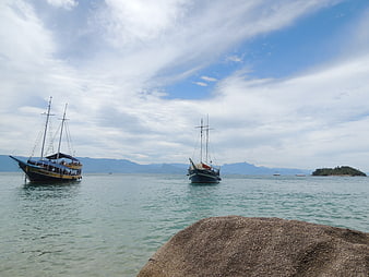 Traditional wooden boats anchored in calm tropical bay