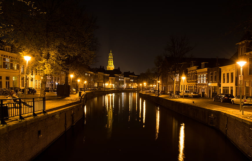 Night view of Groningen canal with illuminated A-kerk tower