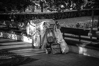 Black and white photo of homeless person's belongings on shopping cart