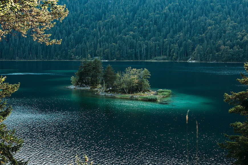 Serene Alpine Lake with Small Forested Island