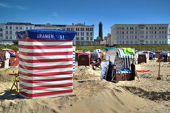 Colorful Beach Huts on Borkum Island with Lighthouse Background