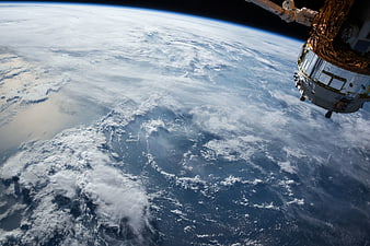 Earth from Space with Satellite Module and Clouds