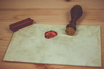 Vintage wax seal on envelope with wooden stamp