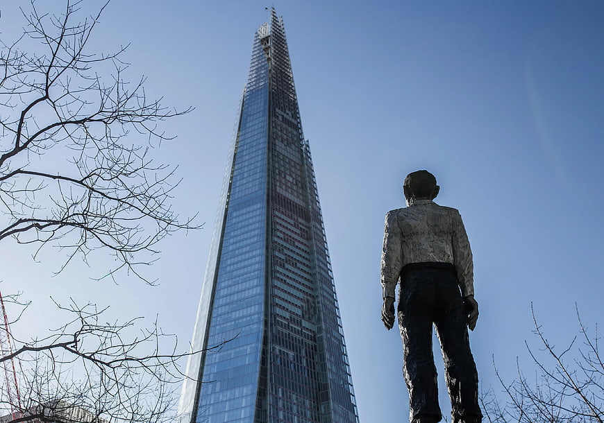 Statue of man looking up at The Shard skyscraper