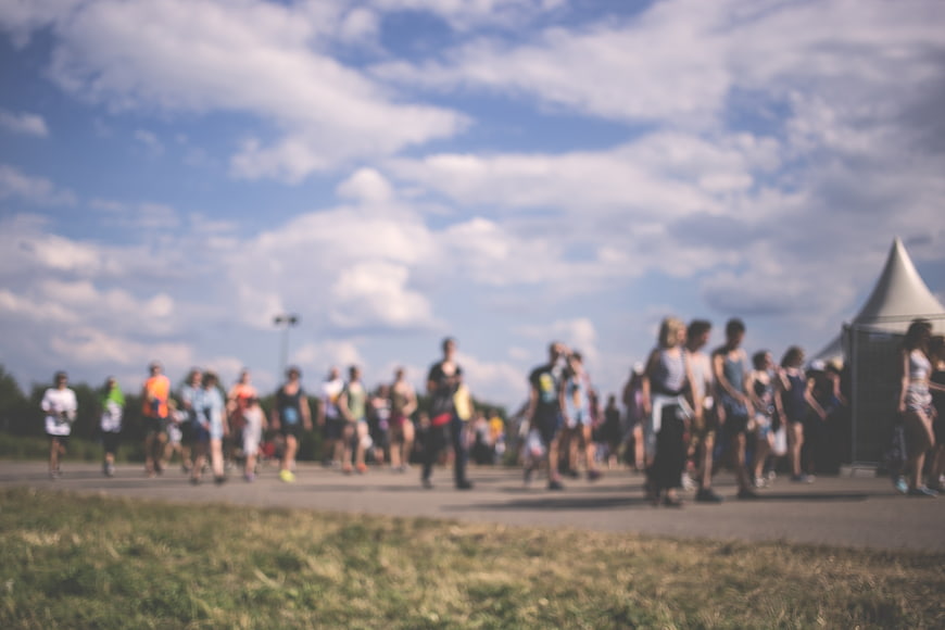 Blurred Crowd Walking Outdoors on Sunny Day