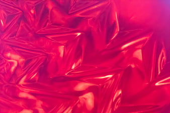 Abstract shiny red crumpled foil texture background