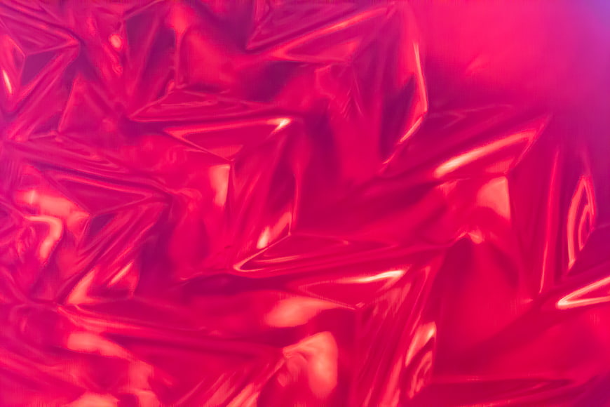 Abstract shiny red crumpled foil texture background