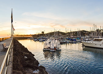 Sailboats in Harbor at Sunset with Pier and Calm Water