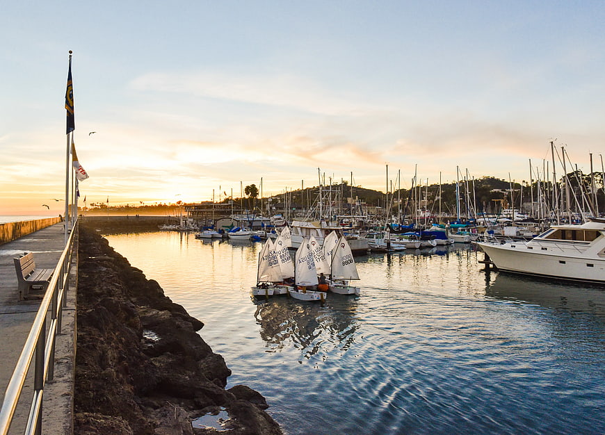 Sailboats in Harbor at Sunset with Pier and Calm Water