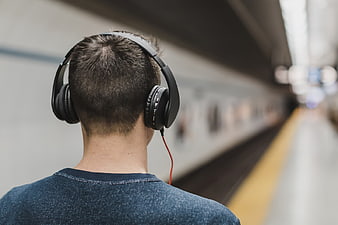 Man with Headphones on Train Platform