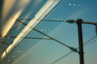 Abstract Reflection of Train Wires and Lights on Glass