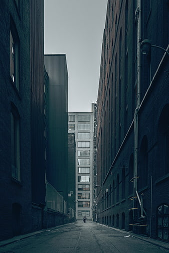 Lone Figure Walking Down Dark Urban Alleyway