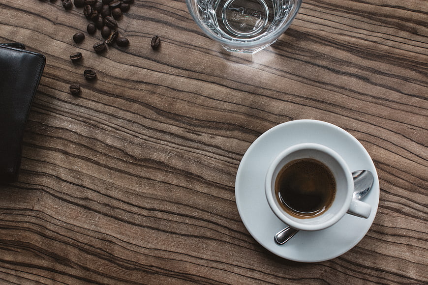 Top View of Espresso Cup on Wooden Table with Coffee Beans