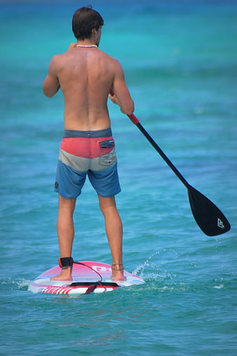 Man Stand Up Paddleboarding on Turquoise Ocean Water