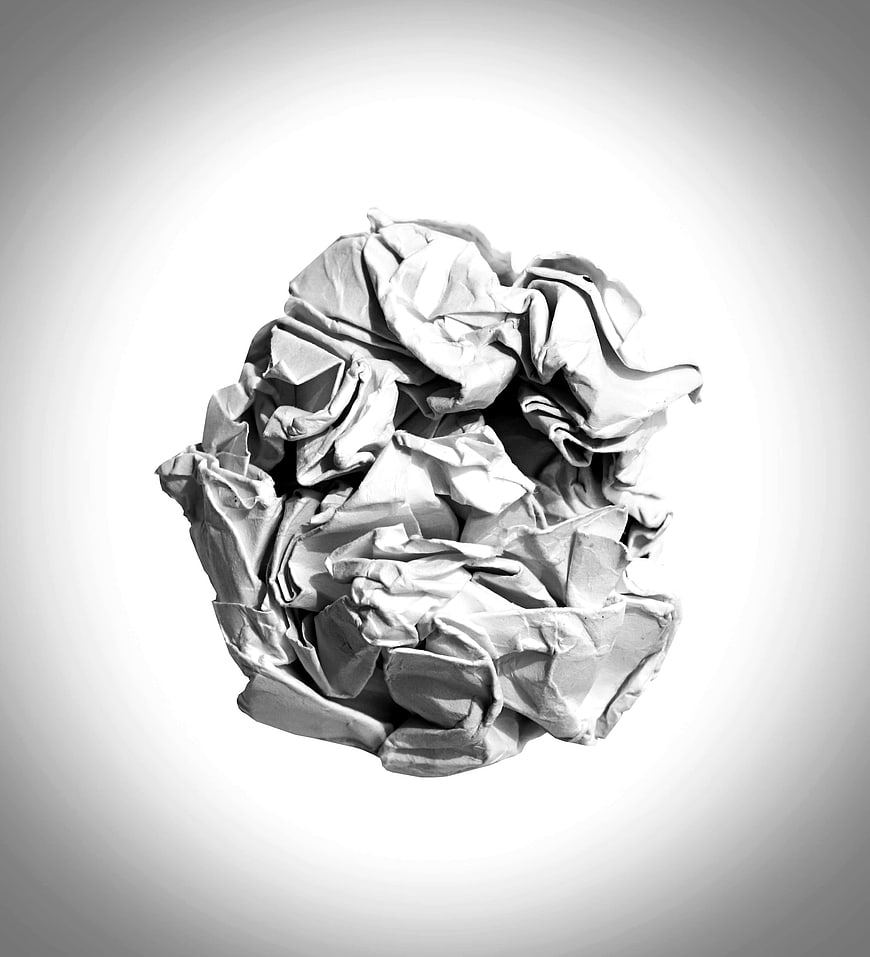 Crumpled white paper ball on gray gradient background